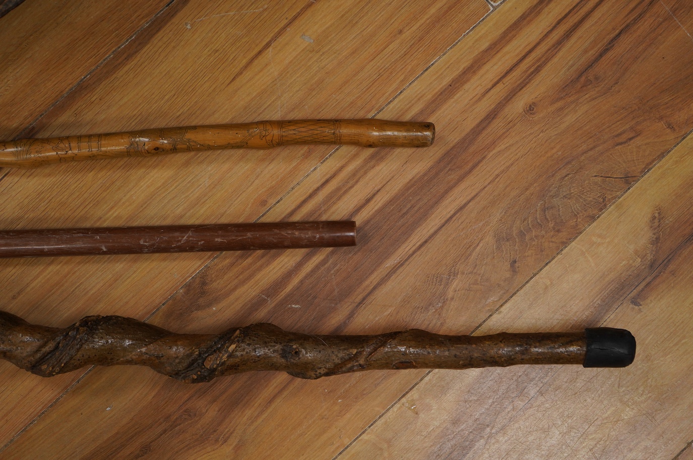 Three novelty walking sticks and gouged gathering bowl. Condition - fair